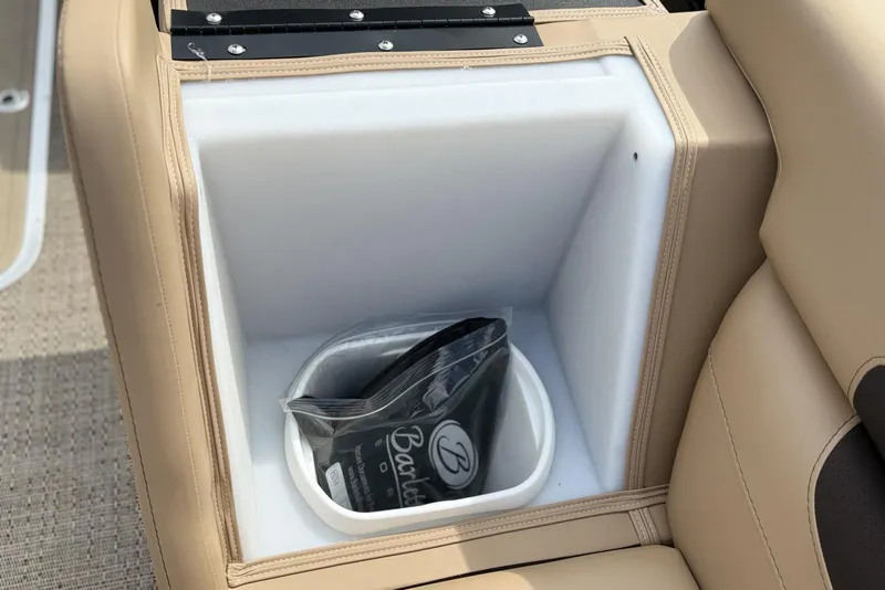 Slide: The Image of Barletta Cabrio 24U 2025 boat storage compartment with beige seating and a black bag. - 10