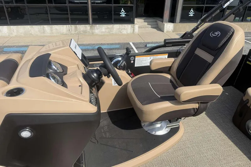 Slide: The Image of Captain's chair and dashboard of 2025 Barletta Cabrio 24U pontoon boat. - 16