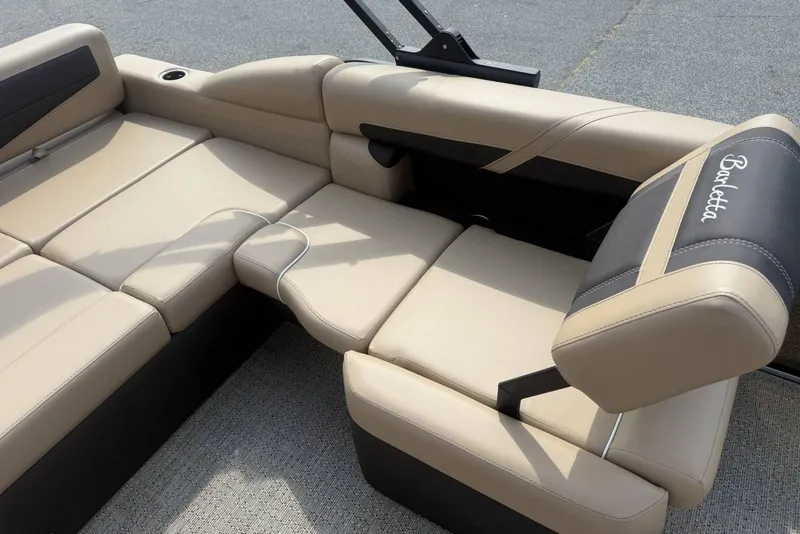 Slide: The Image of Luxurious seating on 2025 Barletta Cabrio 24U boat, featuring beige upholstery and adjustable headrest. - 18