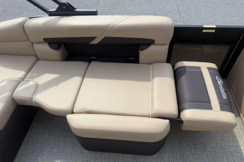 Slide: The Image of 2025 Barletta Cabrio 24U boat interior with beige and black cushioned seating. - 19