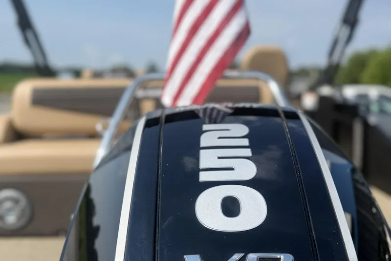 Slide: The Image of Close-up of a 2025 Barletta Cabrio 24U boat engine with American flag. - 2