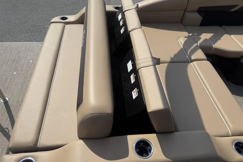 Slide: The Image of Luxurious seating on 2025 Barletta Cabrio 24U pontoon boat, featuring beige upholstery and cup holders. - 23