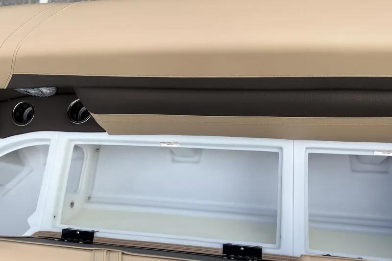 Slide: The Image of 2025 Barletta Cabrio 24U boat storage compartment with beige and brown seating. - 7
