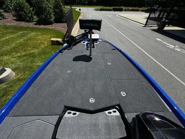 Slide: The Image of 2024 Vexus VXS20 boat deck with trolling motor, parked on a sunny day. - 10