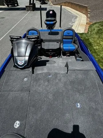 Slide: The Image of 2024 Vexus VXS20 boat with blue accents, spacious deck, and modern seating. - 13
