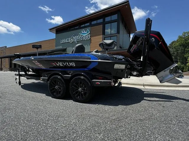 The Image of 2024 Vexus VXS20 boat parked outside Rock Outdoors store under a clear sky. - 1