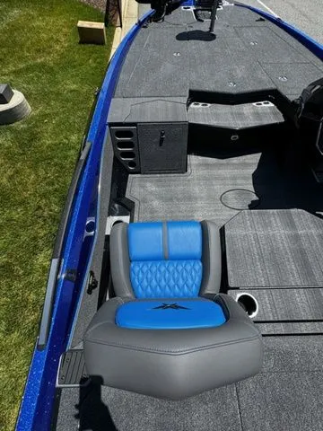 Slide: The Image of 2024 Vexus VXS20 boat with blue and gray seating, spacious deck, and storage compartments. - 9