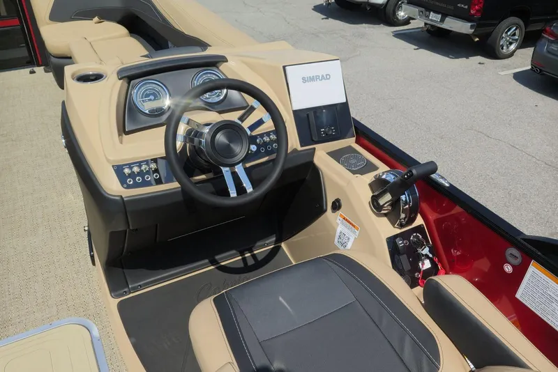 Slide: The Image of 2026 Barletta Cabrio 24UC boat dashboard with steering wheel and controls. - 14