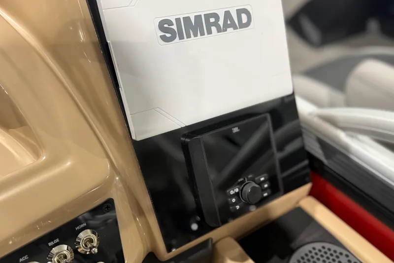 Slide: The Image of Control panel of 2026 Barletta Cabrio 24UC boat featuring Simrad and JBL systems. - 15