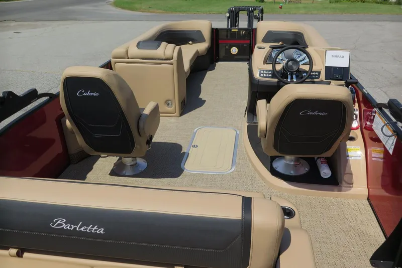 Slide: The Image of 2026 Barletta Cabrio 24UC boat interior with tan seating and modern steering console. - 18