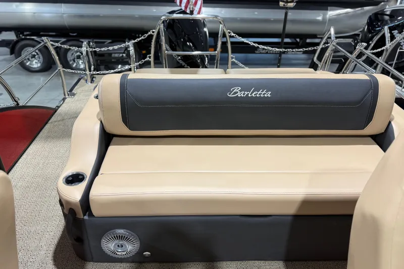 Slide: The Image of 2026 Barletta Cabrio 24UC boat interior with beige seating and cup holder. - 19