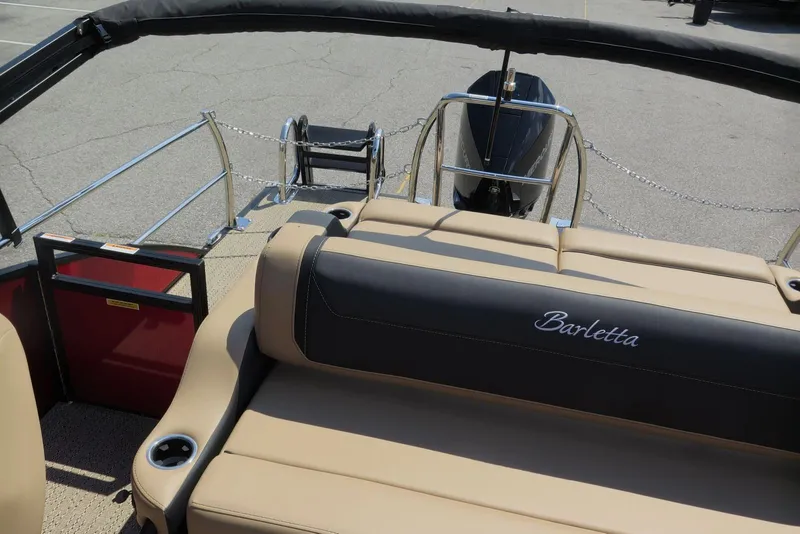 Slide: The Image of 2026 Barletta Cabrio 24UC boat interior with tan seating and branded backrest. - 24