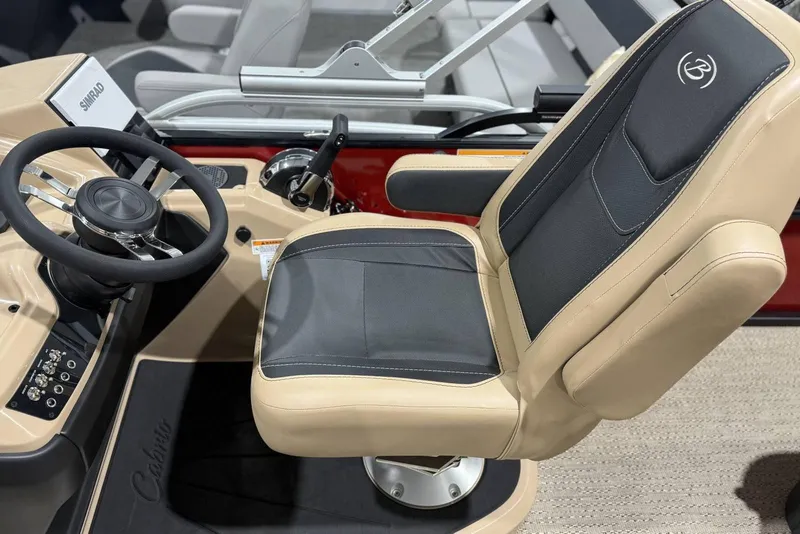 Slide: The Image of Captain's chair and steering wheel of 2026 Barletta Cabrio 24UC boat interior. - 25