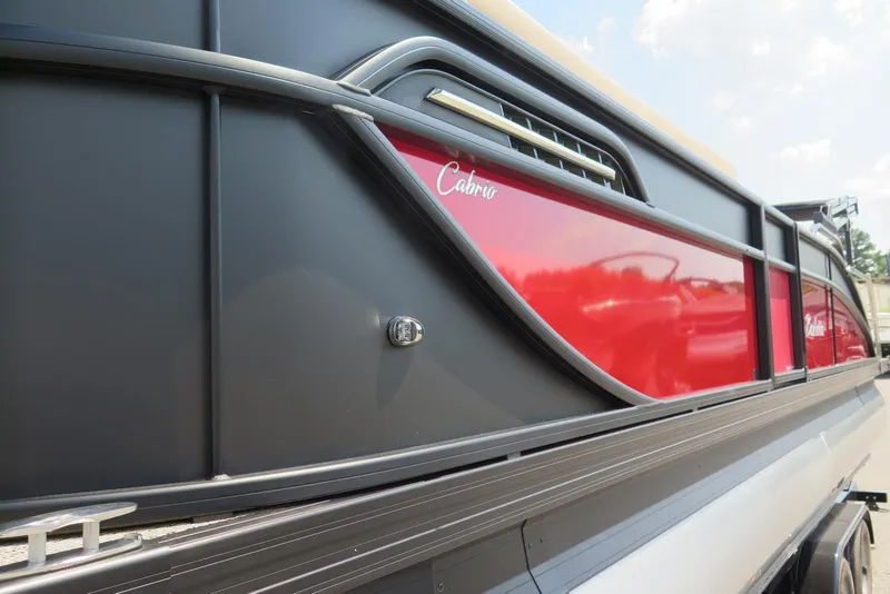 Slide: The Image of 2026 Barletta Cabrio 24UC pontoon boat with sleek red and black design. - 27