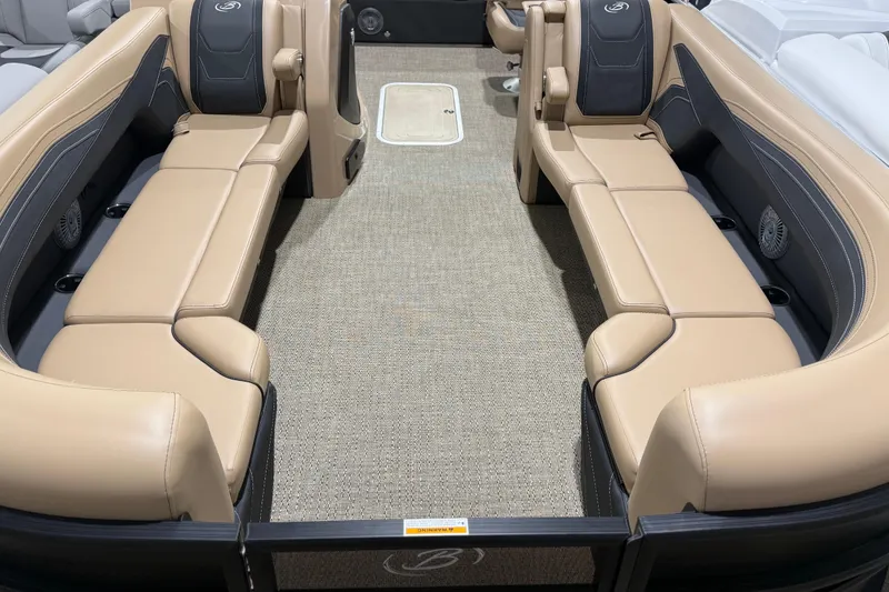 Slide: The Image of 2026 Barletta Cabrio 24UC boat interior with tan seating and carpeted flooring. - 3