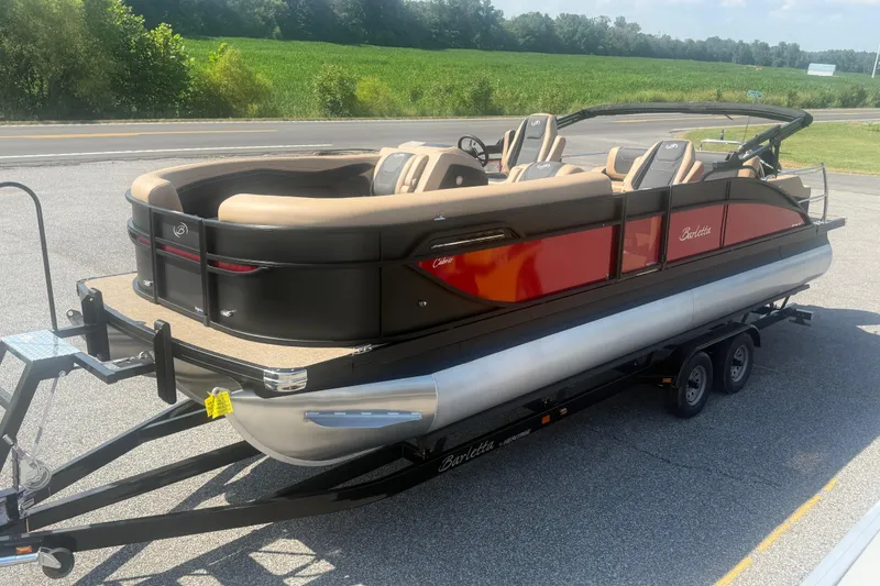 Slide: The Image of 2026 Barletta Cabrio 24UC pontoon boat on trailer, parked near a road. - 33