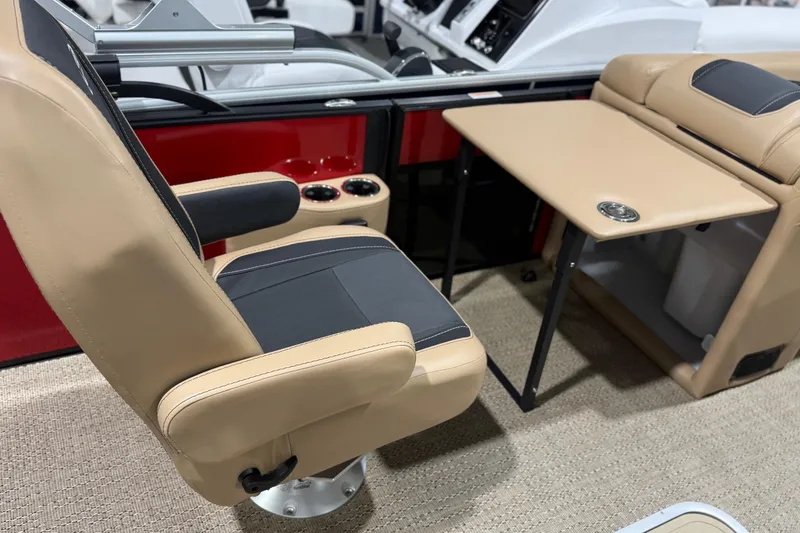Slide: The Image of 2026 Barletta Cabrio 24UC boat interior with beige seating and foldable table. - 9