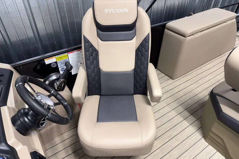Slide: The Image of 2026 Sylvan L3 DLZ boat interior with beige captain's chair and steering wheel. - 12
