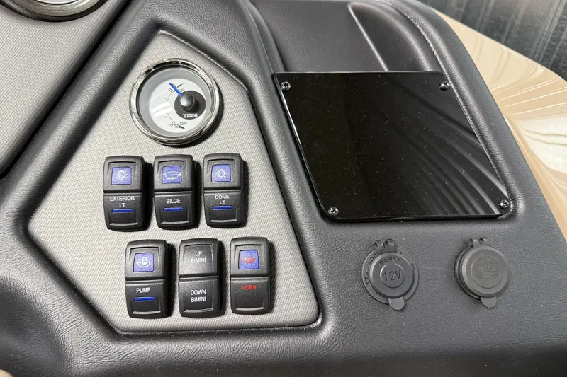 Slide: The Image of Control panel of 2026 Sylvan L3 DLZ boat with switches and trim gauge. - 15