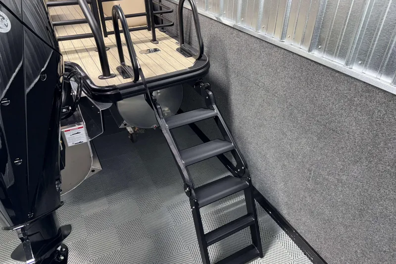 Slide: The Image of 2026 Sylvan L3 DLZ boat with black ladder and wooden deck. - 29