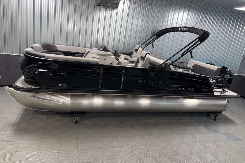 The Image of 2026 Sylvan L3 DLZ Platinum pontoon boat in showroom, sleek black design. - 0