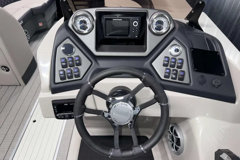 Slide: The Image of Steering console of 2026 Sylvan L3 DLZ Platinum boat with modern controls and gauges. - 12