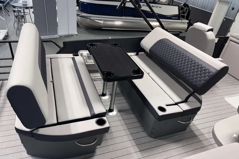 Slide: The Image of 2026 Sylvan L3 DLZ Platinum boat interior with gray seating and a central table. - 17