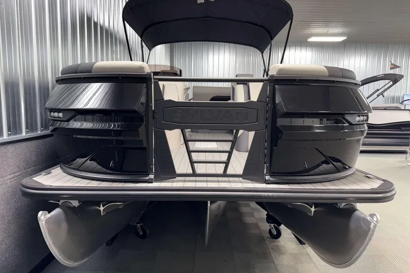 Slide: The Image of 2026 Sylvan L3 DLZ Platinum pontoon boat in showroom, sleek black design. - 22