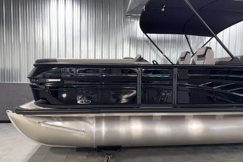 Slide: The Image of 2026 Sylvan L3 DLZ Platinum pontoon boat with sleek black design and modern seating. - 24