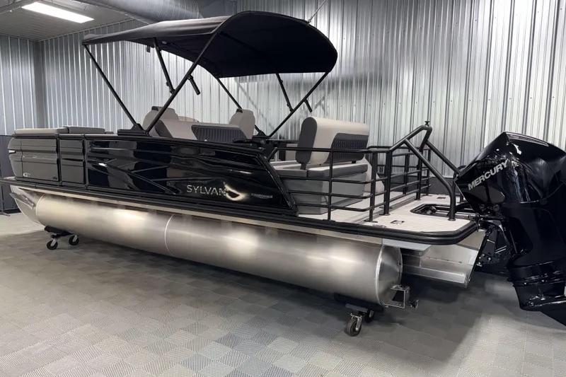 Slide: The Image of 2026 Sylvan L3 DLZ Platinum pontoon boat with Mercury outboard in a showroom. - 27