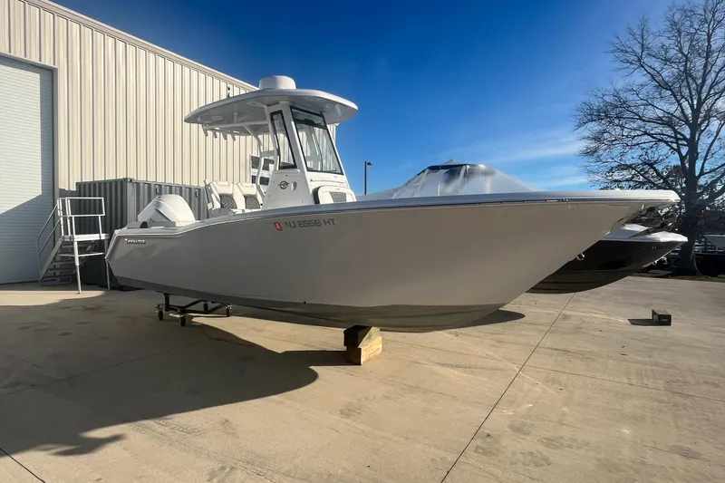 Slide: The Image of 2024 Tidewater 232 LXF boat on display outside a warehouse. - 1