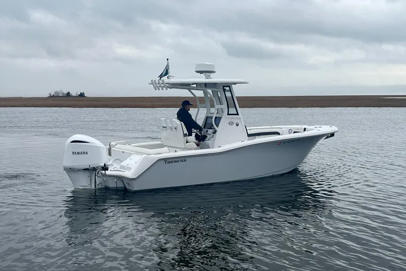 Slide: The Image of 2024 Tidewater 232 LXF boat with Yamaha engine on calm water. - 10