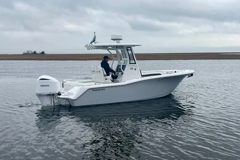 Slide: The Image of 2024 Tidewater 232 LXF boat on calm water with Yamaha engine. - 11
