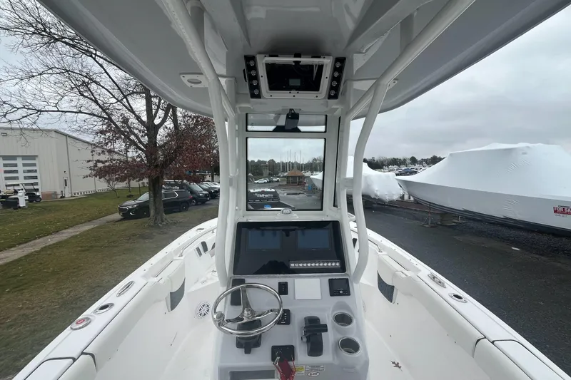 Slide: The Image of 2024 Tidewater 232 LXF boat interior with steering wheel and control panel. - 12