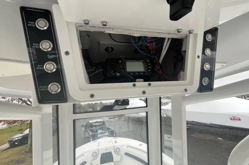 Slide: The Image of 2024 Tidewater 232 LXF boat console with control panel and electronic equipment. - 16