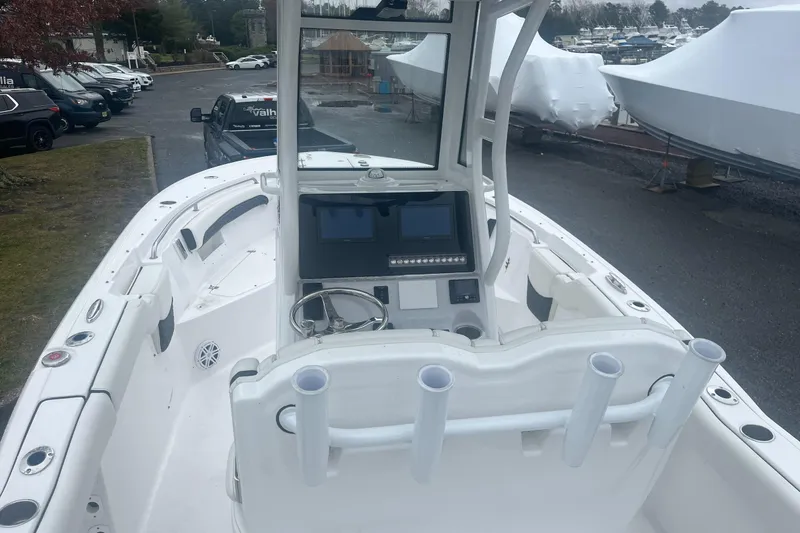 Slide: The Image of 2024 Tidewater 232 LXF boat interior with steering console and rod holders. - 17