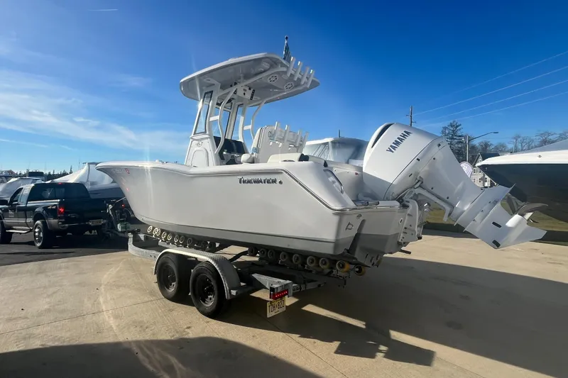 Slide: The Image of 2024 Tidewater 232 LXF boat on trailer with Yamaha engine, parked outdoors. - 3