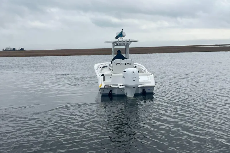 Slide: The Image of 2024 Tidewater 232 LXF boat navigating calm waters under cloudy skies. - 7