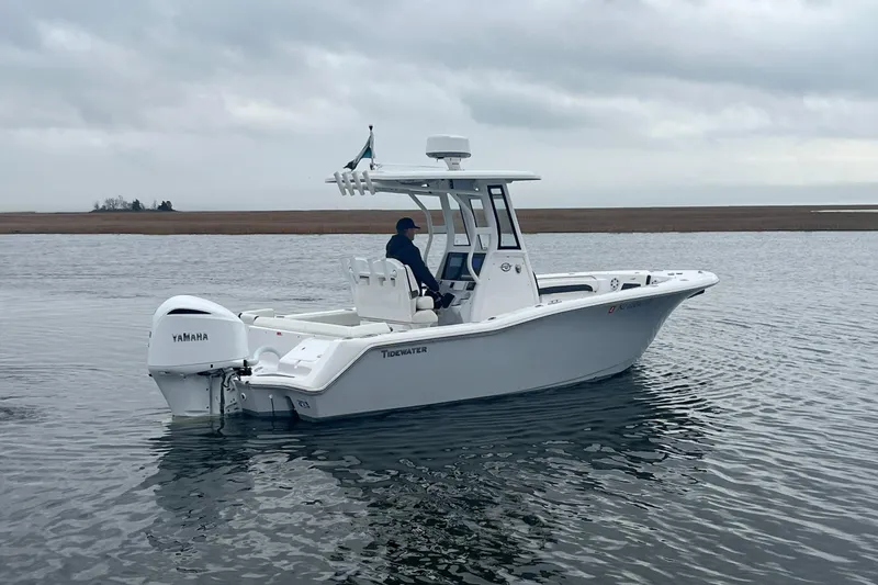 Slide: The Image of 2024 Tidewater 232 LXF boat on calm water, featuring Yamaha engine. - 9