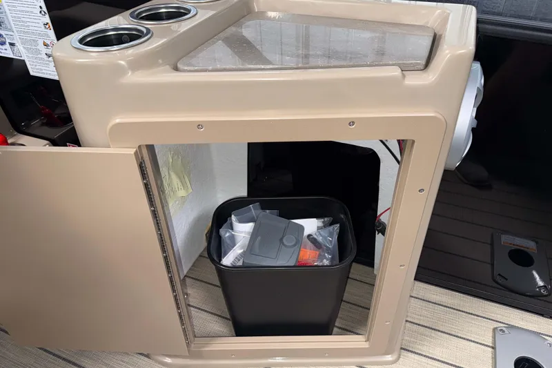 Slide: The Image of Open storage compartment in 2026 Sylvan L3 DLZ Bar with trash bin and cup holders. - 22