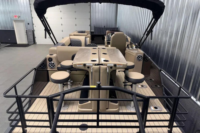 Slide: The Image of 2026 Sylvan L3 DLZ Bar pontoon boat interior with bar stools and seating. - 23