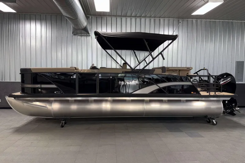 Slide: The Image of 2026 Sylvan L3 DLZ Bar pontoon boat in showroom, side view. - 27