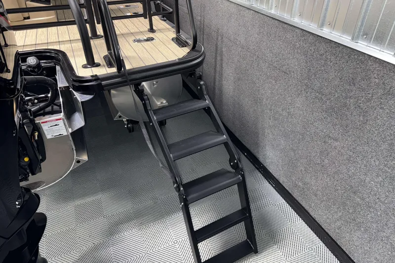 Slide: The Image of 2026 Sylvan L3 DLZ Bar boat with black ladder and wooden deck. - 30