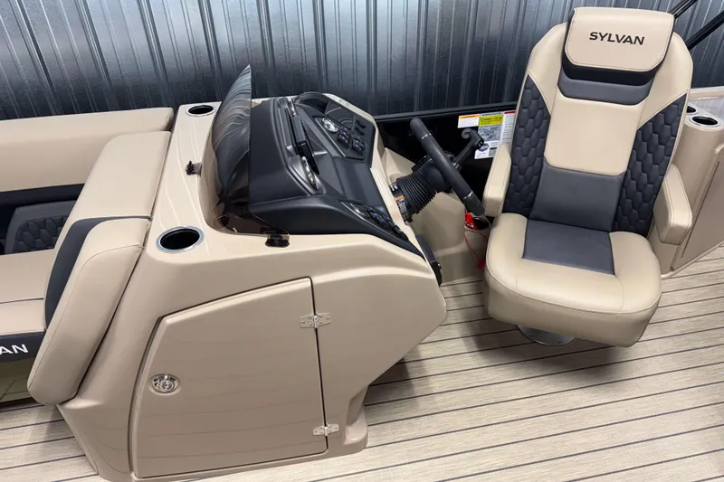 Slide: The Image of 2026 Sylvan L3 DLZ Bar boat interior with beige and black seating, steering console. - 7