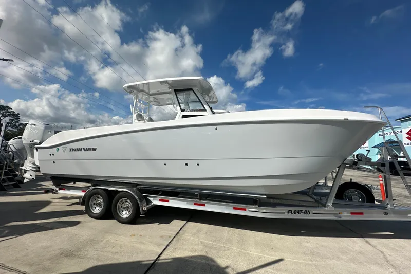The Image of 2026 Twin Vee 280 GFX2 CC boat on trailer under blue sky. - 1
