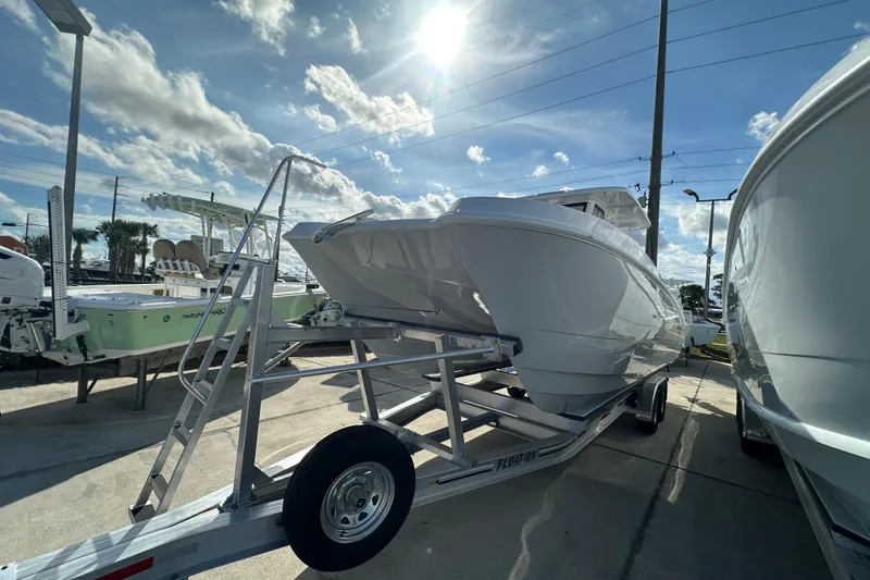 Slide: The Image of 2026 Twin Vee 280 GFX2 CC boat on trailer under sunny sky. - 2