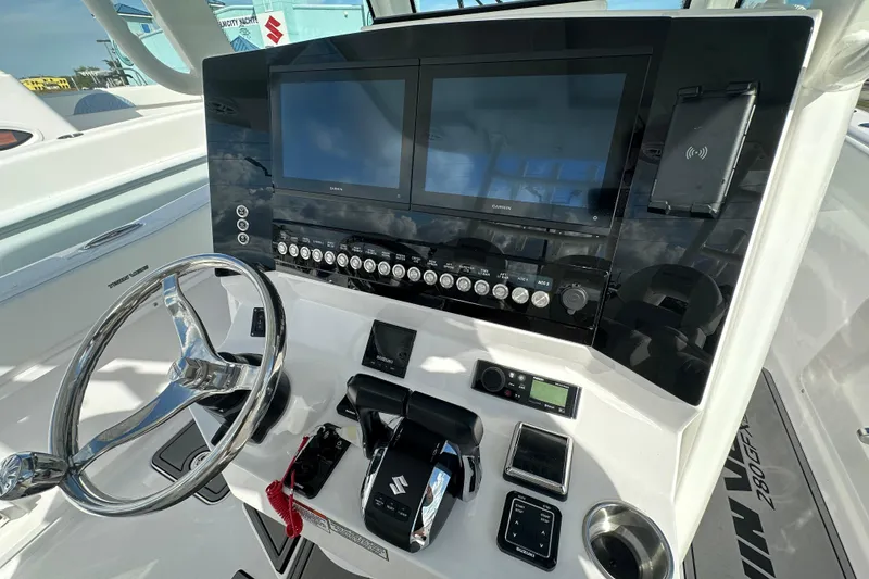 Slide: The Image of 2026 Twin Vee 280 GFX2 CC boat dashboard with dual screens and steering wheel. - 5