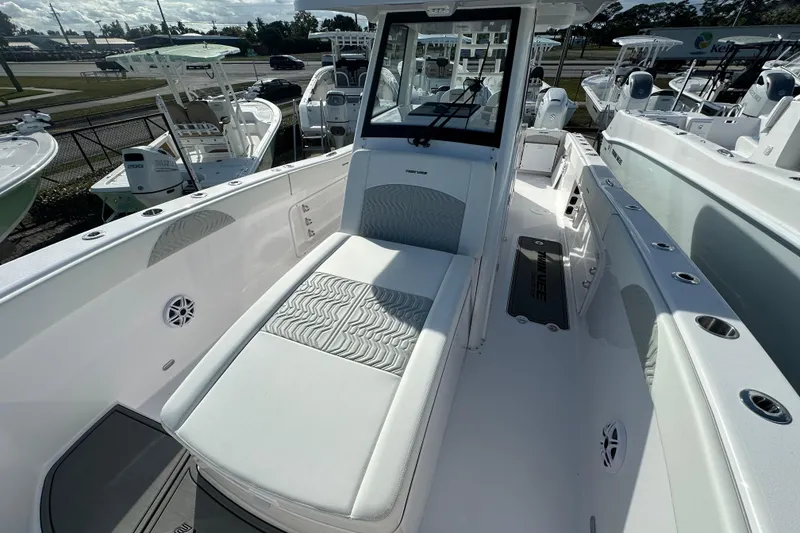 Slide: The Image of 2026 Twin Vee 280 GFX2 CC boat interior with cushioned seating and sleek design. - 7