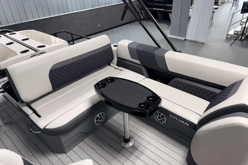 Slide: The Image of 2026 Sylvan L3 DLZ Bar pontoon boat interior with stylish seating and table. - 17