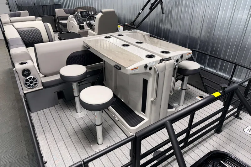 Slide: The Image of 2026 Sylvan L3 DLZ Bar pontoon boat interior with bar stools and modern seating. - 21